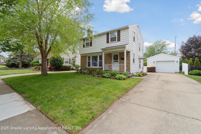 1023 N Hayford Ave, Lansing, MI 48912 - traditional-style home featuring an outdoor structure, a detached garage, a front yard, and a porch