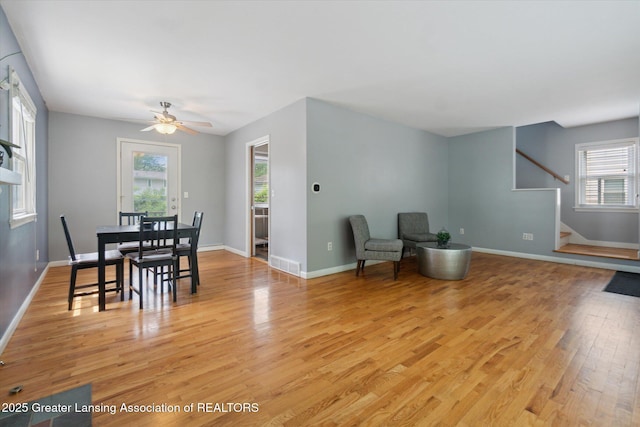 1023 N Hayford Ave, Lansing, MI 48912 - dining space with light wood-type flooring, stairway, baseboards, and a ceiling fan