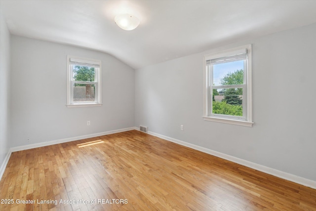 1023 N Hayford Ave, Lansing, MI 48912 - bonus room featuring vaulted ceiling, light wood-style floors, and baseboards