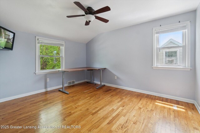 1023 N Hayford Ave, Lansing, MI 48912 - unfurnished room featuring healthy amount of natural light, vaulted ceiling, wood finished floors, and ceiling fan