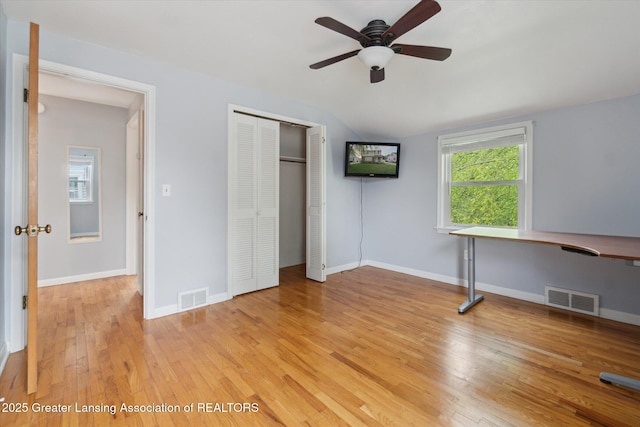 1023 N Hayford Ave, Lansing, MI 48912 - unfurnished bedroom featuring vaulted ceiling, light wood-type flooring, a closet, ceiling fan, and baseboards