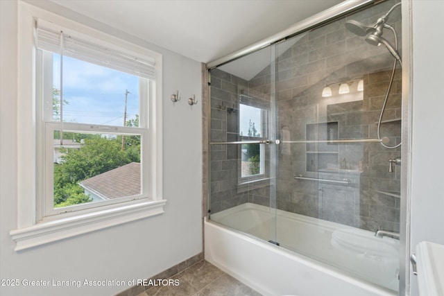 1023 N Hayford Ave, Lansing, MI 48912 - bathroom featuring combined bath / shower with glass door, baseboards, and tile patterned floors