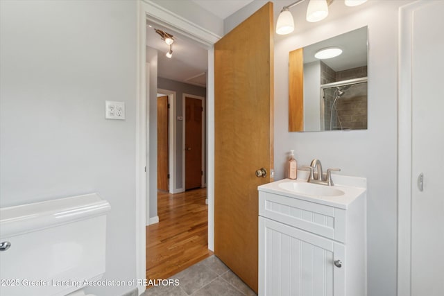 1023 N Hayford Ave, Lansing, MI 48912 - full bath with vanity, tiled shower, tile patterned flooring, and toilet