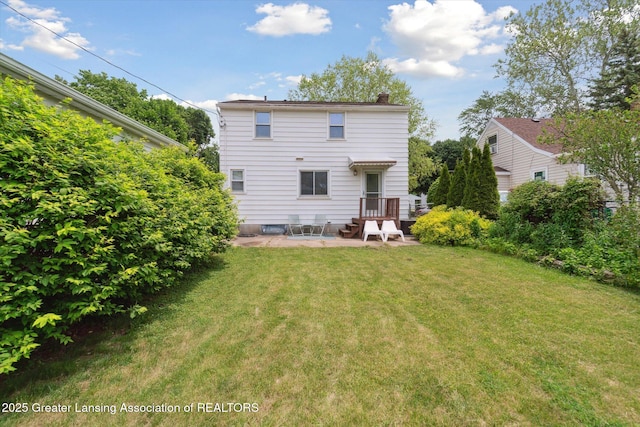 1023 N Hayford Ave, Lansing, MI 48912 - rear view of property with a chimney, a yard, and a patio