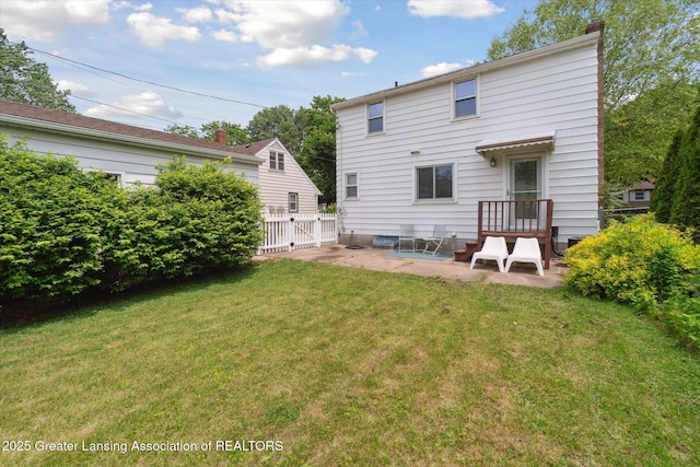 1023 N Hayford Ave, Lansing, MI 48912 - back of house with a patio area, a gate, and a chimney