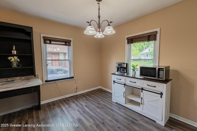 522 W Hodge Ave, Lansing, MI 48910 - home office featuring dark wood finished floors, healthy amount of natural light, a chandelier, and baseboards