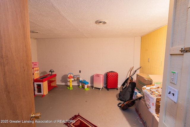 522 W Hodge Ave, Lansing, MI 48910 - playroom with finished concrete flooring and a textured ceiling