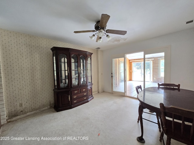 6322 Springport Rd, Eaton Rapids, MI 48827 - carpeted dining space featuring a ceiling fan and wallpapered walls