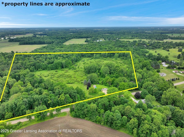 6322 Springport Rd, Eaton Rapids, MI 48827 - aerial view of property and surrounding area with property boundaries highlighted and a heavily wooded area
