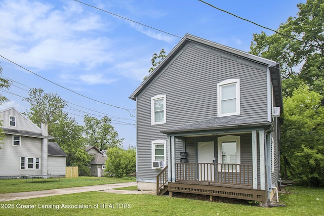 413 N Pennsylvania Ave, Lansing, MI 48912 - view of front of house with covered porch, a front yard, and cooling unit