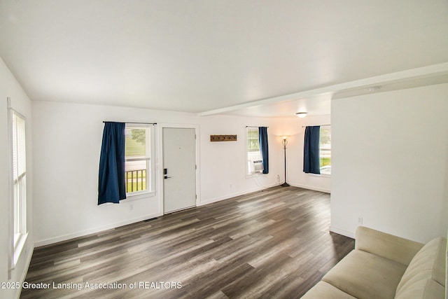 413 N Pennsylvania Ave, Lansing, MI 48912 - unfurnished living room featuring dark wood-style floors, baseboards, and cooling unit