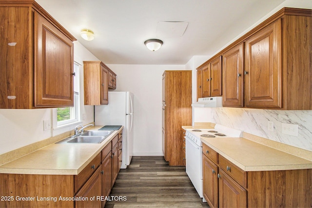 413 N Pennsylvania Ave, Lansing, MI 48912 - kitchen with white appliances, a sink, under cabinet range hood, and brown cabinetry