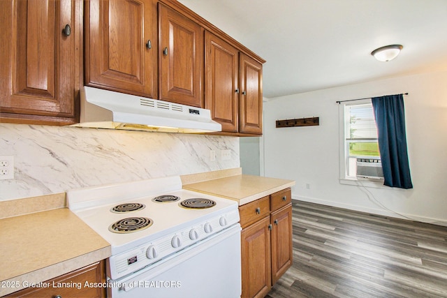 413 N Pennsylvania Ave, Lansing, MI 48912 - kitchen with white electric stove, under cabinet range hood, brown cabinets, decorative backsplash, and cooling unit