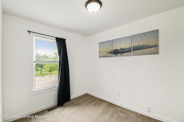 413 N Pennsylvania Ave, Lansing, MI 48912 - spare room with baseboards and light colored carpet
