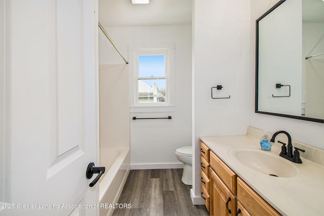 413 N Pennsylvania Ave, Lansing, MI 48912 - bathroom featuring vanity, wood finished floors, baseboards, toilet, and shower / bath combination
