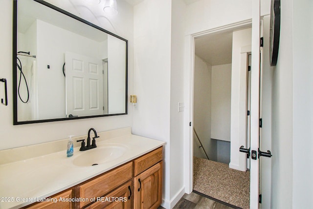 413 N Pennsylvania Ave, Lansing, MI 48912 - bathroom with vanity, wood finished floors, and baseboards