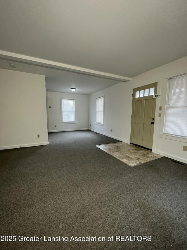 413 N Pennsylvania Ave, Lansing, MI 48912 - foyer entrance featuring dark carpet and baseboards
