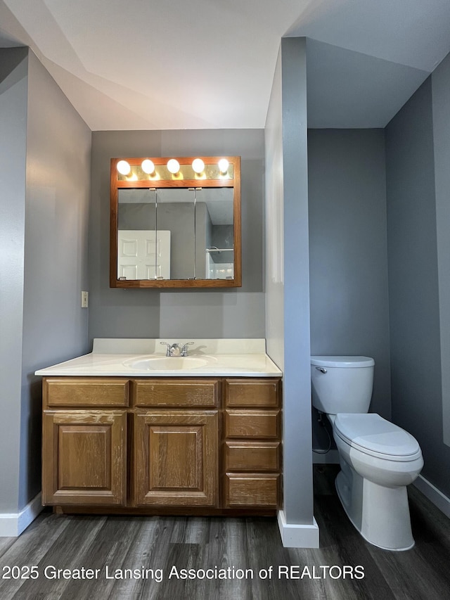 413 N Pennsylvania Ave, Lansing, MI 48912 - bathroom featuring wood finished floors, baseboards, and vanity