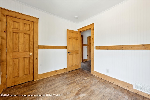 402 W Cesar E Chavez Ave, Lansing, MI 48906 - empty room with ornamental molding, wood finished floors, and a smoke detector