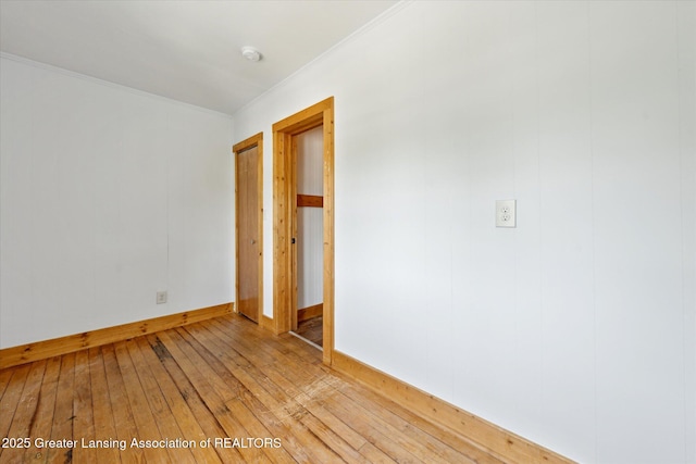 402 W Cesar E Chavez Ave, Lansing, MI 48906 - spare room with light wood finished floors, ornamental molding, a smoke detector, and baseboards