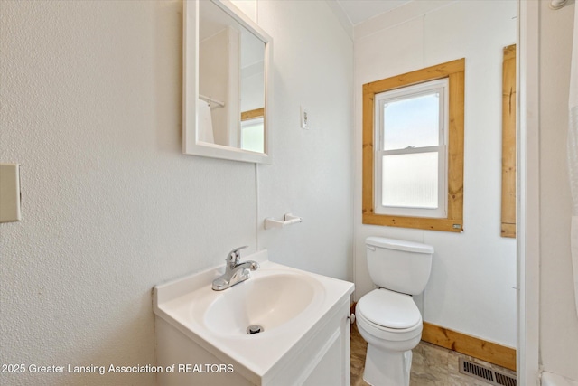 402 W Cesar E Chavez Ave, Lansing, MI 48906 - bathroom with vanity, toilet, and baseboards