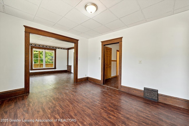402 W Cesar E Chavez Ave, Lansing, MI 48906 - unfurnished room featuring wood finished floors, baseboards, and a drop ceiling