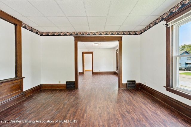 402 W Cesar E Chavez Ave, Lansing, MI 48906 - unfurnished room with wood finished floors, a drop ceiling, and baseboards