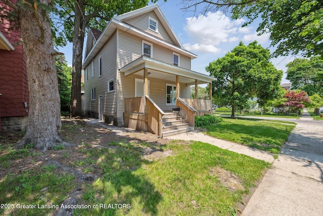 402 W Cesar E Chavez Ave, Lansing, MI 48906 - traditional style home featuring covered porch and a front lawn