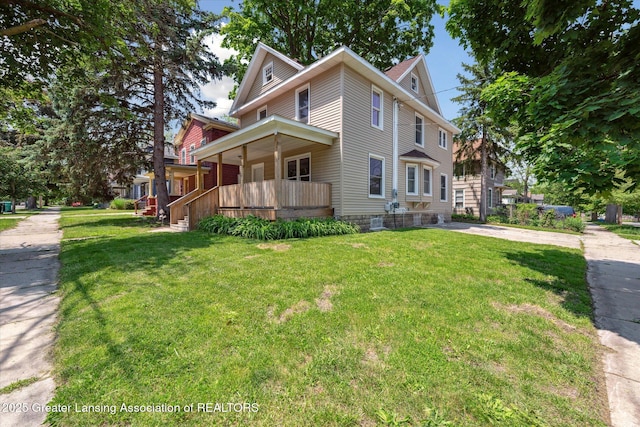 402 W Cesar E Chavez Ave, Lansing, MI 48906 - view of property exterior featuring covered porch and a yard