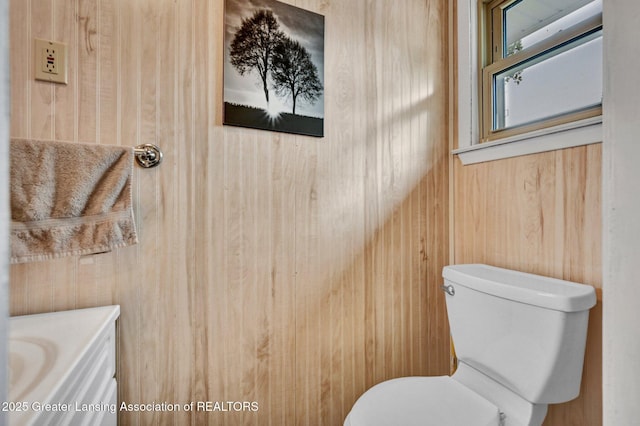 7713 Jon Scott Dr, Grand Ledge, MI 48837 - bathroom with wood walls, toilet, and vanity