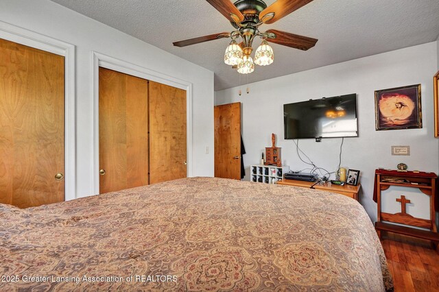 7713 Jon Scott Dr, Grand Ledge, MI 48837 - bedroom featuring wood finished floors, a textured ceiling, and ceiling fan
