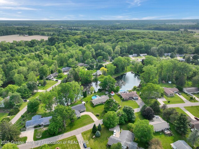 7713 Jon Scott Dr, Grand Ledge, MI 48837 - aerial view of residential area featuring a large body of water and a heavily wooded area