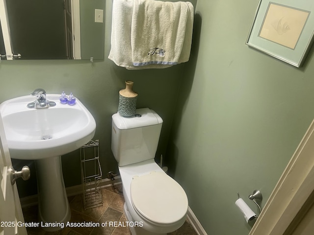 1745 Maisonette Dr, Lansing, MI 48911 - bathroom featuring baseboards and toilet