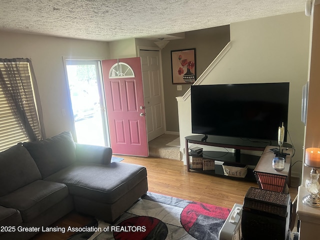 1745 Maisonette Dr, Lansing, MI 48911 - living room with wood finished floors and a textured ceiling