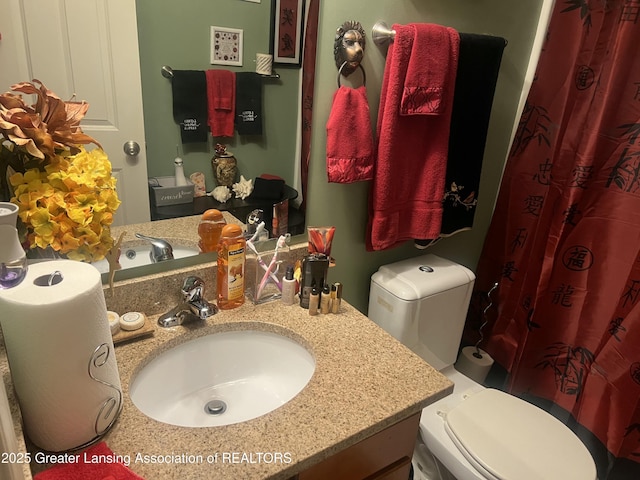 1745 Maisonette Dr, Lansing, MI 48911 - bathroom with toilet, vanity, and a shower with shower curtain