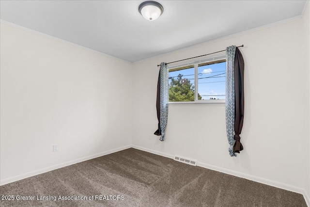 1941 S Royston Rd, Eaton Rapids, MI 48827 - spare room with dark carpet, crown molding, and baseboards