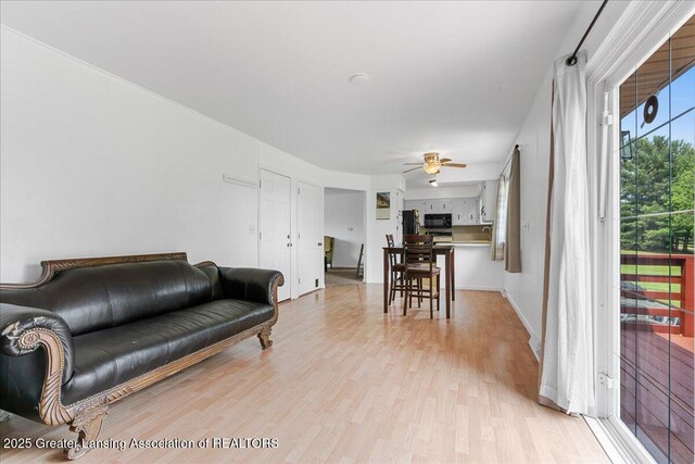1941 S Royston Rd, Eaton Rapids, MI 48827 - living room with a ceiling fan and light wood-style floors