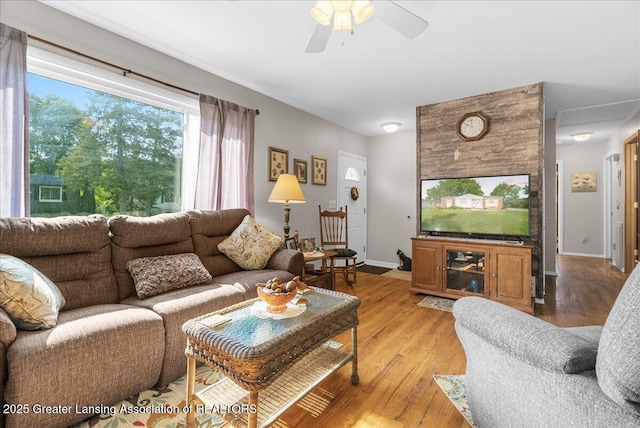 1727 Springfield Ln, Lansing, MI 48912 - living room featuring light wood finished floors, a ceiling fan, and baseboards