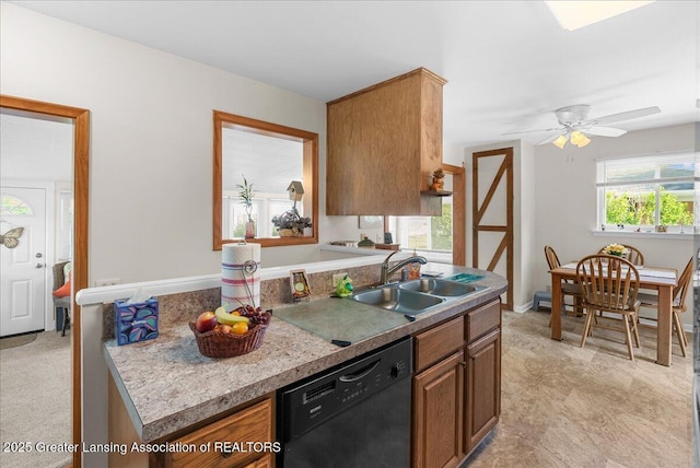1727 Springfield Ln, Lansing, MI 48912 - kitchen with dishwasher, a sink, a ceiling fan, light countertops, and brown cabinets