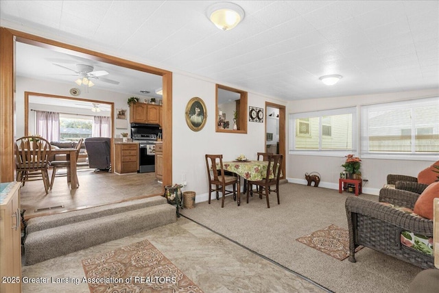 1727 Springfield Ln, Lansing, MI 48912 - living room with ceiling fan, baseboards, and light carpet