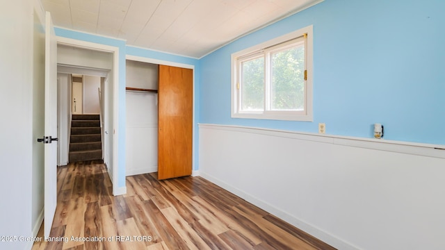 3326 W Willow St, Lansing, MI 48917 - unfurnished bedroom with a closet, wood finished floors, and baseboards