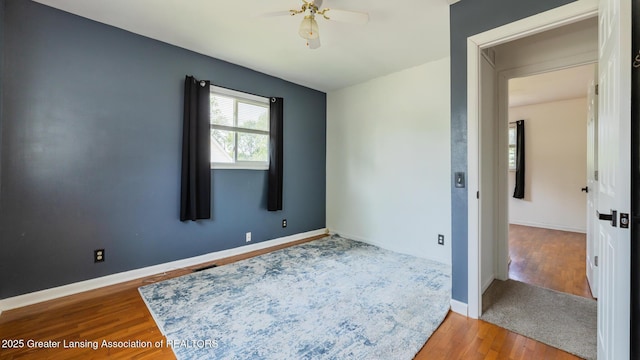 3326 W Willow St, Lansing, MI 48917 - unfurnished room featuring wood finished floors, ceiling fan, and baseboards