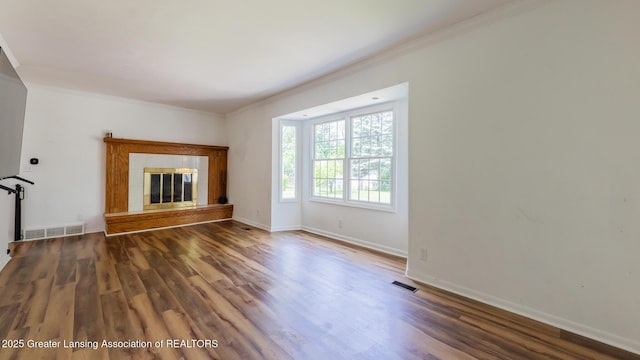 3326 W Willow St, Lansing, MI 48917 - unfurnished living room with ornamental molding, wood finished floors, baseboards, and a fireplace