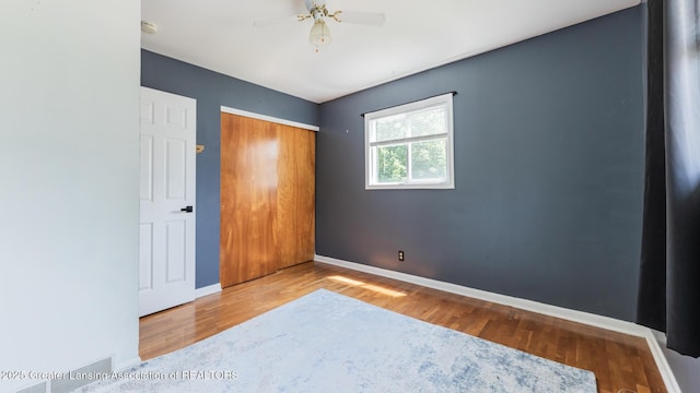 3326 W Willow St, Lansing, MI 48917 - unfurnished bedroom featuring wood finished floors, baseboards, and a closet