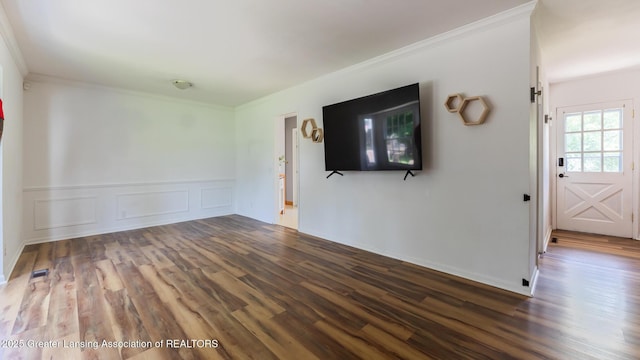 3326 W Willow St, Lansing, MI 48917 - unfurnished living room with wood finished floors, crown molding, and wainscoting
