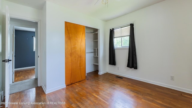 3326 W Willow St, Lansing, MI 48917 - unfurnished bedroom with a closet, wood finished floors, and baseboards