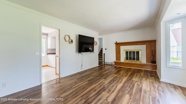 3326 W Willow St, Lansing, MI 48917 - unfurnished living room with ornamental molding, wood finished floors, plenty of natural light, and stairway