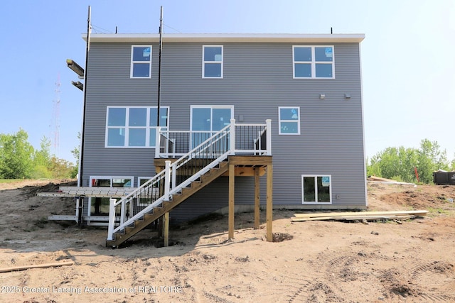 605 Landbridge, Perry, MI 48872 - back of property with stairway and a deck