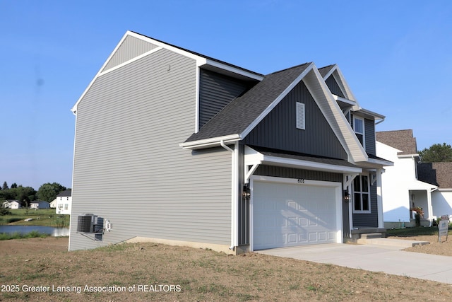 605 Landbridge, Perry, MI 48872 - view of property exterior with concrete driveway, a shingled roof, and a garage