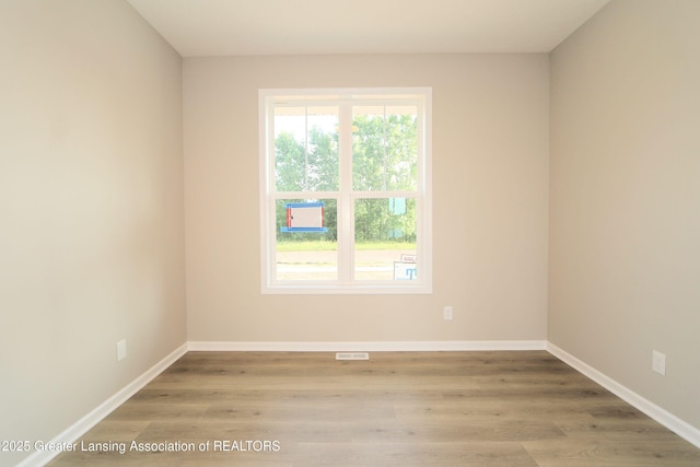 605 Landbridge, Perry, MI 48872 - unfurnished room featuring wood finished floors and baseboards
